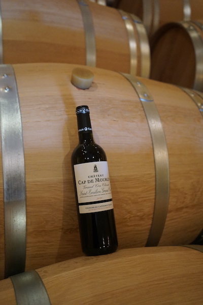 Château Cap de Mourlin bottle on barrel in the malolactic cellar